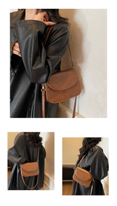 Detail view of brown vintage PU leather crossbody bag with gold metal hardware and flap closure