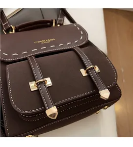 Close-up of vintage brown leather backpack showing suede contrast and contrast stitching