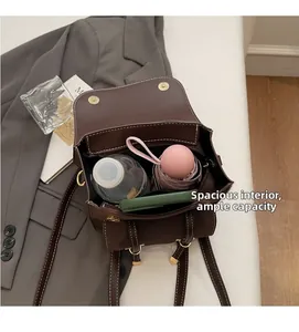 Detail of dark brown leather bag showing large capacity for umbrella and gadgets