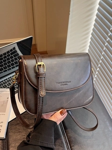 Retro dark brown oily leather crossbody bag with adjustable strap and embossed detail