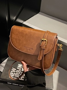 Retro brown leather crossbody bag with vintage texture and gold hardware detail