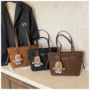 Three vintage tote bags in caramel black and brown with plush bear charms and metal logo