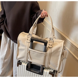 Detail of travel tote bag with specialized suitcase sleeve for easy attachment to luggage