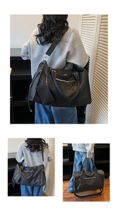 Detailed view of black large capacity travel bag showing handbag and crossbody options