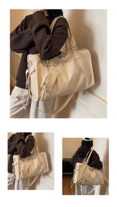 Detail view of large cream travel tote bag with leather texture and detachable small pouch