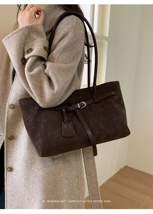 Side view of large dark coffee tote bag with matte texture and decorative buckle