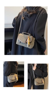 Close-up of vintage dark green suede crossbody bag with retro ethnic charm and bead tassel