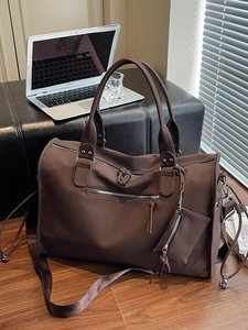 Minimalist large brown travel bag with high-density nylon texture and crossbody strap