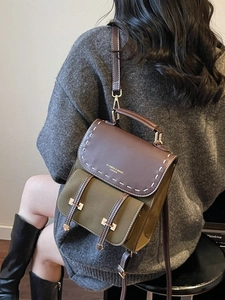 Retro color-block mini backpack with contrast stitching and leather flap shown on model