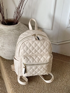 Minimalist cream quilted backpack with golden zippers and adjustable straps for women