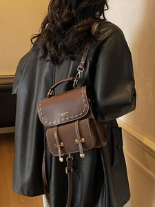 Brown vintage leather backpack with white stitching and IT CHICK lettering detail