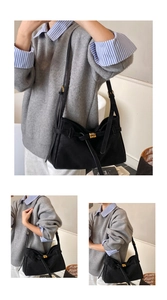 Detail of the large black suede tote bag with stylish gold metal buckle and strap