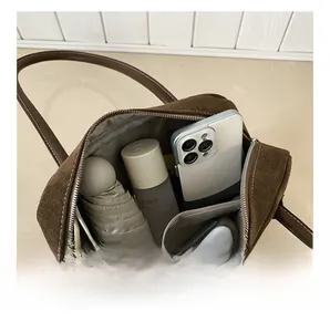 Internal view of large capacity vintage pillow bag with herringbone fabric lining