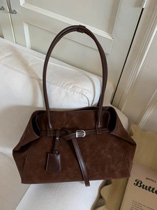 Retro dark brown suede large tote bag with buckle detail on a white sofa setting