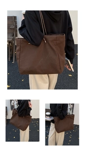 Detail view of large brown canvas tote bag with slim leather straps and drawstring closure