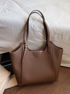 Brown lychee leather tote bag with large capacity and HWTU detail in lifestyle setting
