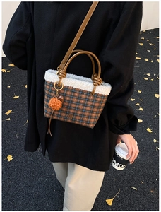 Brown plaid plush bucket bag styled in autumn street scene with falling ginkgo leaves
