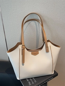 Large cream tote bag with brown handles and lychee grain leather finish in a modern style