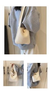 Detailed close-up of a cream knitted crossbody bag featuring a natural wooden horn button closure