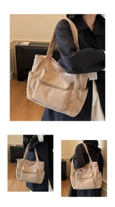 Detail view of corduroy tote bag with multiple pockets and functional storage compartments