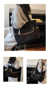 Detail of black corduroy tote bag featuring multiple pockets and white tassel keychain