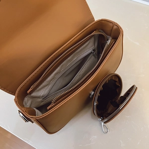 Internal view of minimalist crossbody bag showing herringbone lining and small coin purse