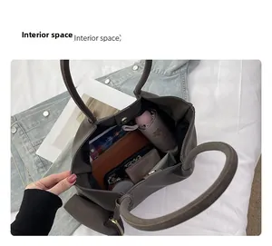 Detail view of large tote bag interior showing ample space for umbrella and wallet