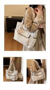 Detail of corduroy tote bag with olive trim, multiple pockets and vintage textured finish