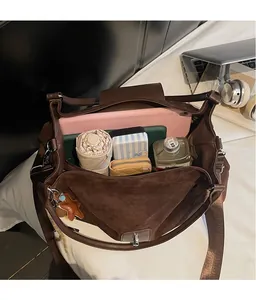 Interior view of large capacity dark brown suede tote bag holding tablet and umbrella