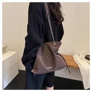 Deep brown frosted bucket bag with gold fashion lettering and chain strap detail