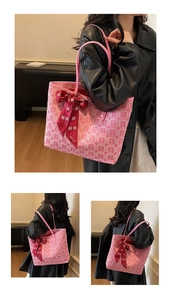 Close-up of pink tote bag featuring white double happiness pattern and red silk ribbon