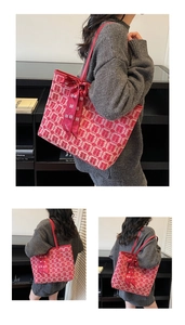 Detail of red bridal tote bag with Xi character jacquard and satin bow decoration