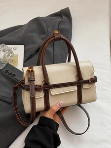 Retro cream crossbody handbag with brown leather strap and gold buckle detail