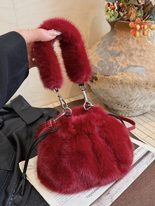 Chic burgundy faux fur bucket bag with plush handle and silver metal hardware