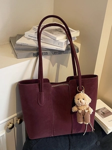 Minimalist burgundy large tote bag in matte leather with a cute plush bear charm