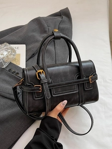 Retro black leather handbag with white contrast stitching and vintage gold hardware accents