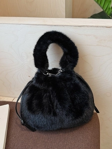 Chic black faux fur bucket bag with plush handle and drawstring closure for winter