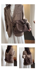 Macro view of dark brown frosted shoulder bag with gold chain and large capacity