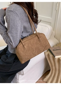 Minimalist retro brown rectangle shoulder bag with matte leather texture shown on a model