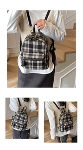 Close-up of black and white checkered wool backpack with gold zippers and leather trim