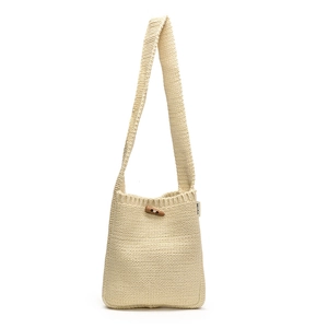 Minimalist cream knit crossbody bag with wooden horn buckle and textured stitch detail