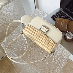 Close-up of cream crossbody bag featuring straw flap design and silver fashion buckle