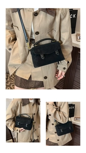 Detail of vintage matte leather crossbody bag with flap and retro round buckles on handle