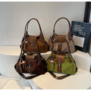 Group shot of suede tote bags in four colors with cute bear charms on a display stand