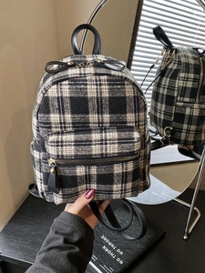 Women's black and white checkered plaid backpack with tweed texture and bow detail