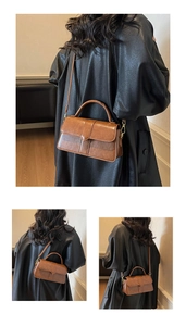 Detail of a brown vintage square handbag with glossy PU leather and gold hardware