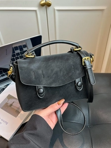Chic black crossbody handbag for women with flap design and gold hardware accessories