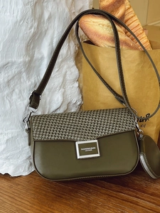 Green leather crossbody bag with woven texture flap and small round coin purse charm