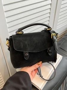 Chic black faux suede crossbody bag for women with gold buckles and adjustable strap