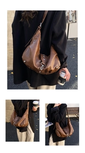 Detail view of brown leather hobo bag with silver star rivets and moon shape design